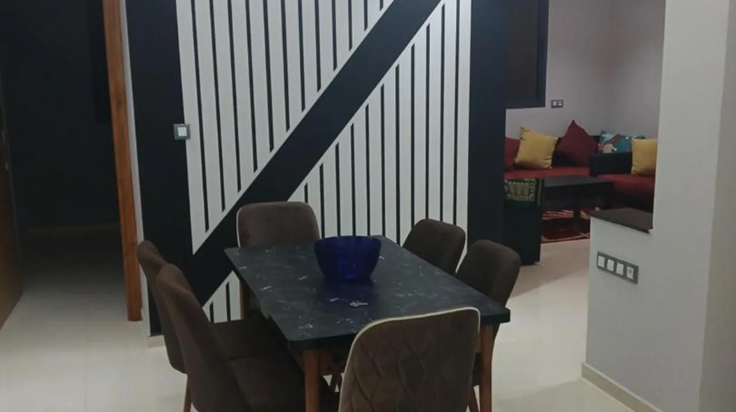 a dining room with a table and chairs at تجزئة الفتح 925 خريبكة 4 in Khouribga