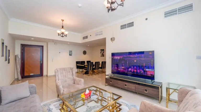 una sala de estar con televisor de pantalla plana y muebles en Ajman Luxurious Holiday Homes en Ajman