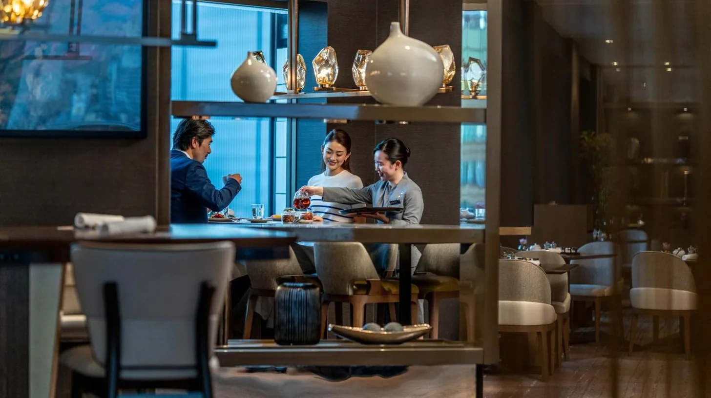 a group of people sitting at a table in a restaurant at ANA InterContinental Tokyo by IHG in Tokyo