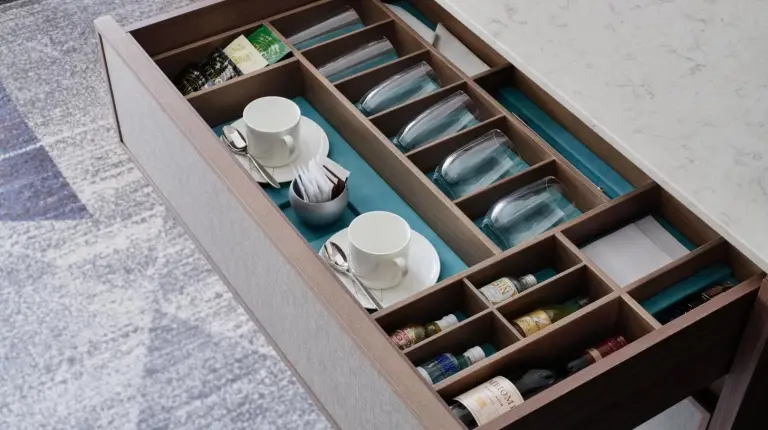 a wooden drawer with cups and dishes in it at ANA InterContinental Tokyo by IHG in Tokyo