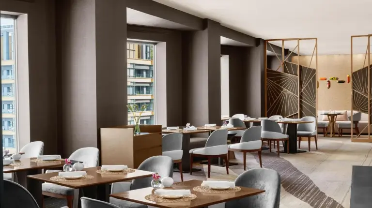 a restaurant with tables and chairs and windows at ANA InterContinental Tokyo by IHG in Tokyo