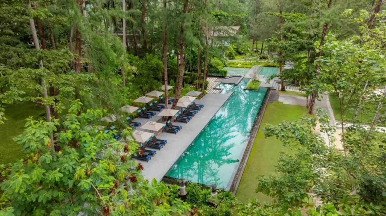 an overhead view of a swimming pool with chairs and trees at Avani Plus Khao Lak Resort in Khao Lak