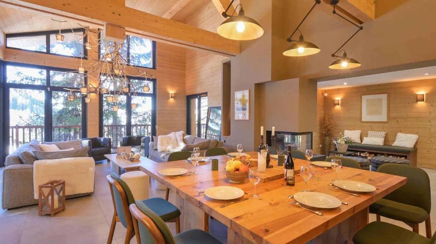 a large wooden table and chairs in a living room at Chalet avec Piscine La Plagne in La Plagne Tarentaise