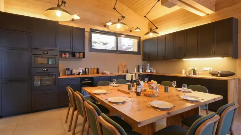 a large kitchen with a wooden table and chairs at Chalet avec Piscine La Plagne in La Plagne Tarentaise