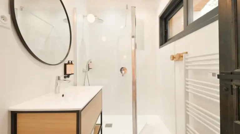 a bathroom with a sink and a mirror at Chalet avec Piscine La Plagne in La Plagne Tarentaise