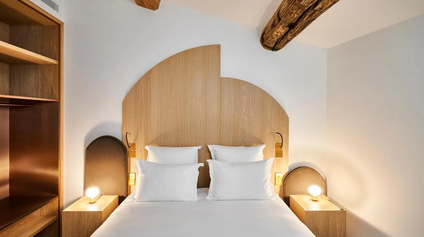a bedroom with a large bed with two lamps at Château de la Gaude in Aix-en-Provence