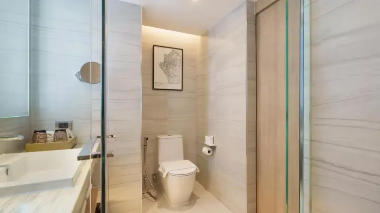 a bathroom with a toilet and a sink at Courtyard by Marriott North Pattaya in Pattaya North