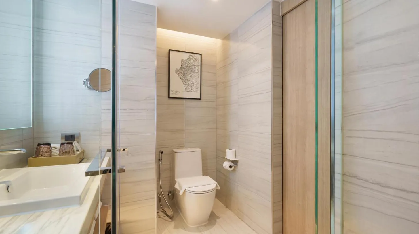 a bathroom with a toilet and a sink at Courtyard by Marriott North Pattaya in Pattaya North