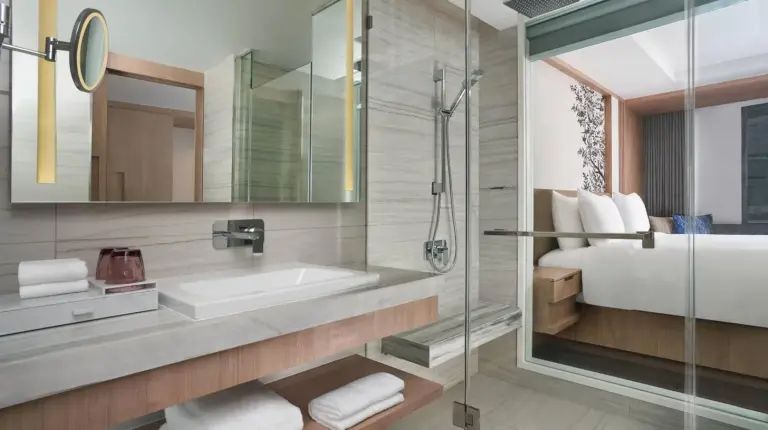 a bathroom with a shower and a sink and a tub at Courtyard by Marriott North Pattaya in Pattaya North