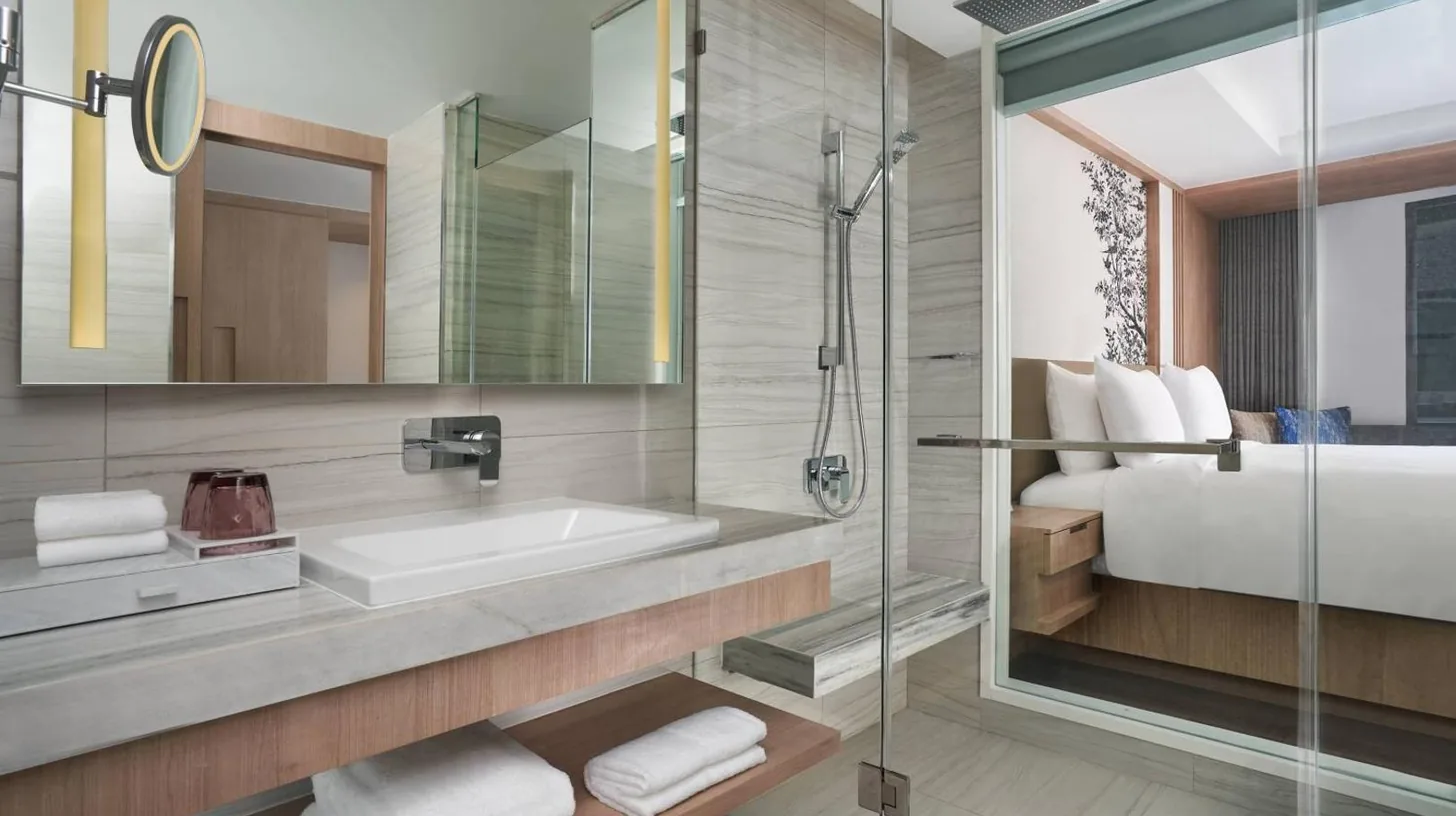 a bathroom with a shower and a sink and a tub at Courtyard by Marriott North Pattaya in Pattaya North