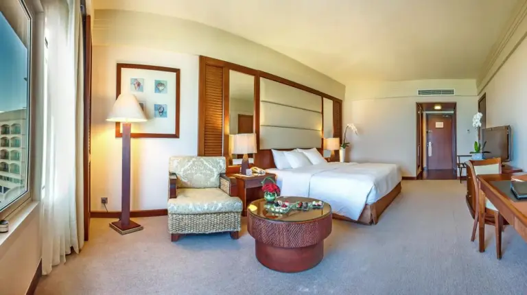 a large hotel room with a bed and a desk at Danat Jebel Dhanna Resort in Jebel Dhanna
