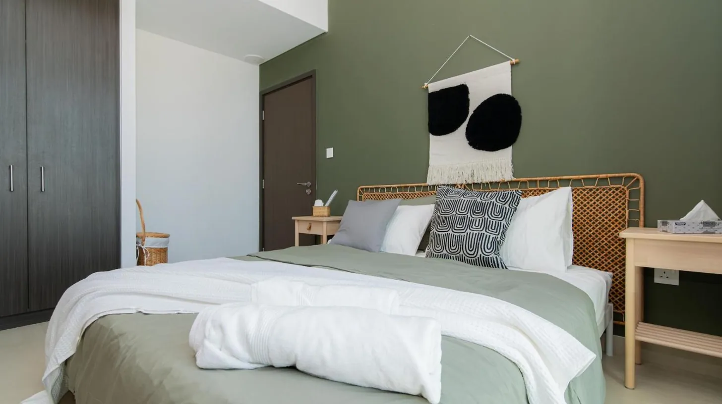 a bedroom with a large bed with white sheets and pillows at Elite Escape Holiday Home - 2 BHK Getaway with Dubai Mall Access - 1508 in Dubai