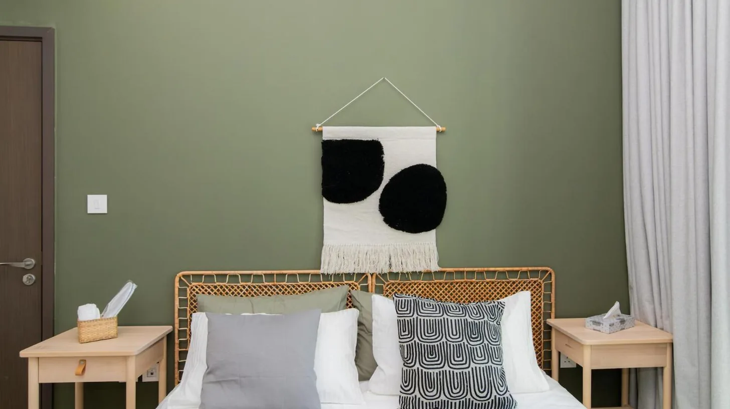 a bedroom with a bed with black and white pillows at Elite Escape Holiday Home - 2 BHK Getaway with Dubai Mall Access - 1508 in Dubai
