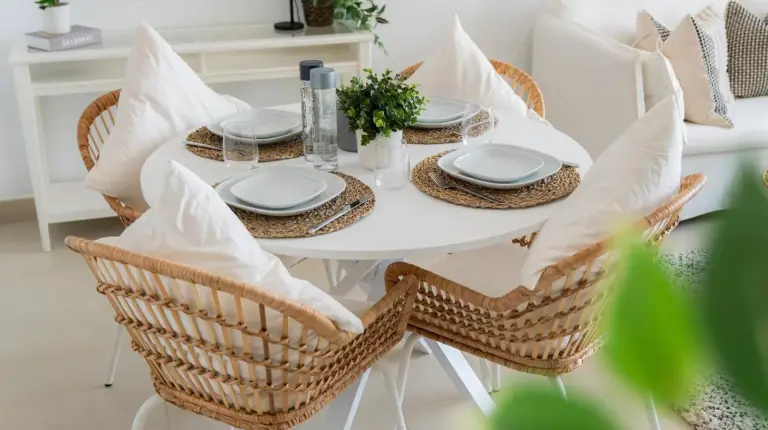 a white dining room table with chairs and pillows at Elite Escape Holiday Home - 2 BHK Getaway with Burj Khalifa View and Dubai Mall Access - 1507 in Dubai