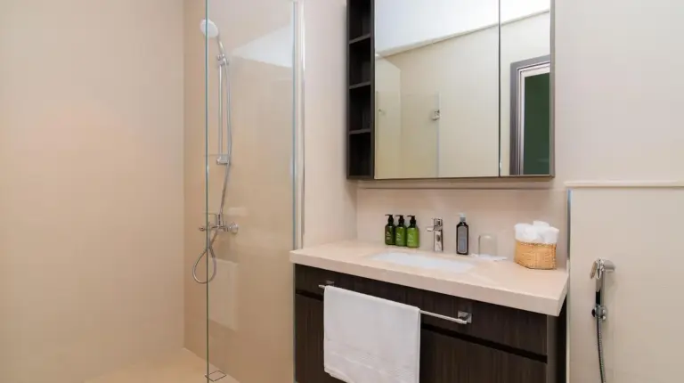 a bathroom with a shower and a sink and a mirror at Elite Escape Holiday Home - 2 BHK Getaway with Dubai Mall Access - 1508 in Dubai