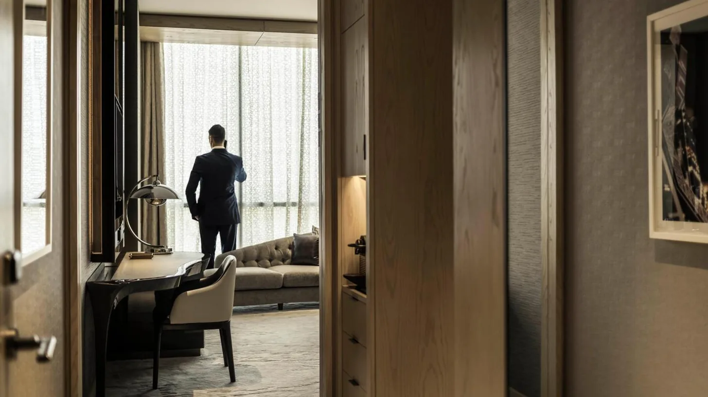 ein Mann im Anzug, der aus einem Fenster schaut, im Four Seasons Hotel Dubai International Financial Centre in Dubai