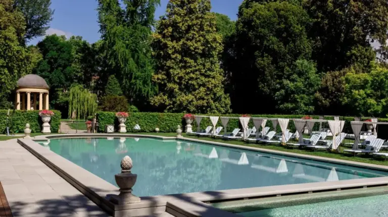 a swimming pool with lounge chairs and a gazebo at Four Seasons Hotel Firenze in Florence