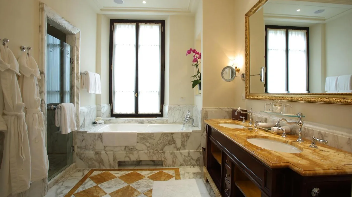 a bathroom with a tub and a sink and a mirror at Four Seasons Hotel Firenze in Florence