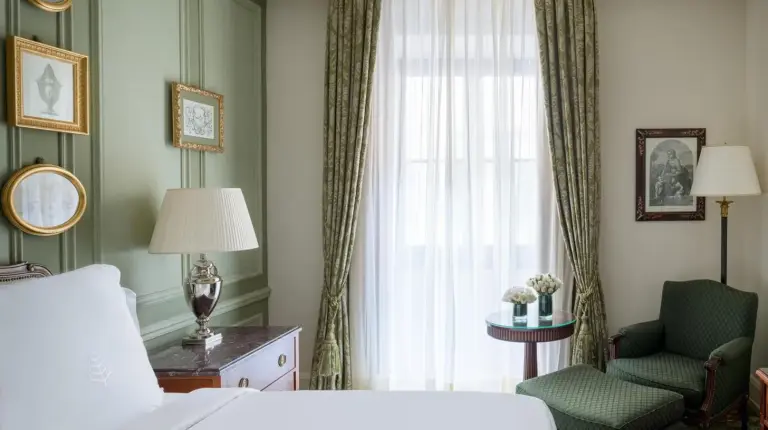 a bedroom with a bed and a chair and a window at Four Seasons Hotel Firenze in Florence