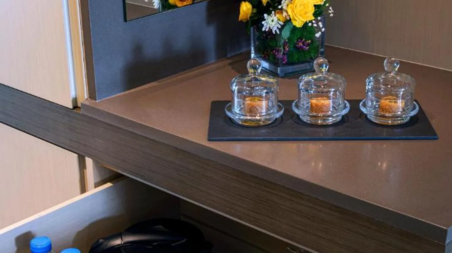 a cupboard with a drawer with flowers in it at Fujairah Rotana Resort & Spa - Al Aqah Beach in Al Aqah