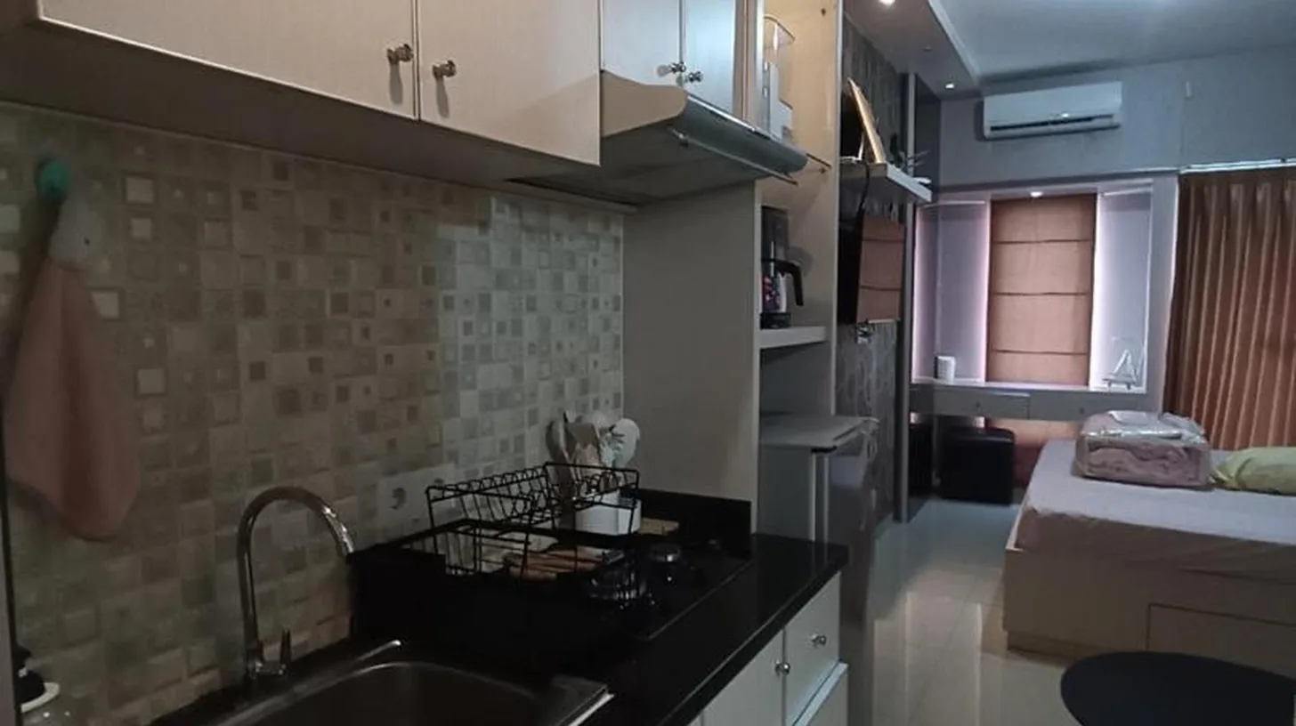 a kitchen with a sink and a counter top at Gatotkaca Hotels in Surabaya