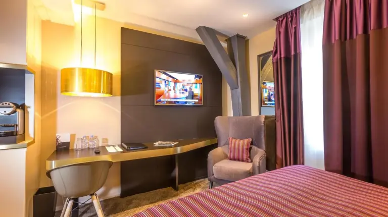 a bedroom with a large painting of a bride on the wall at Grand Hôtel La Cloche Dijon - MGallery Collection in Dijon