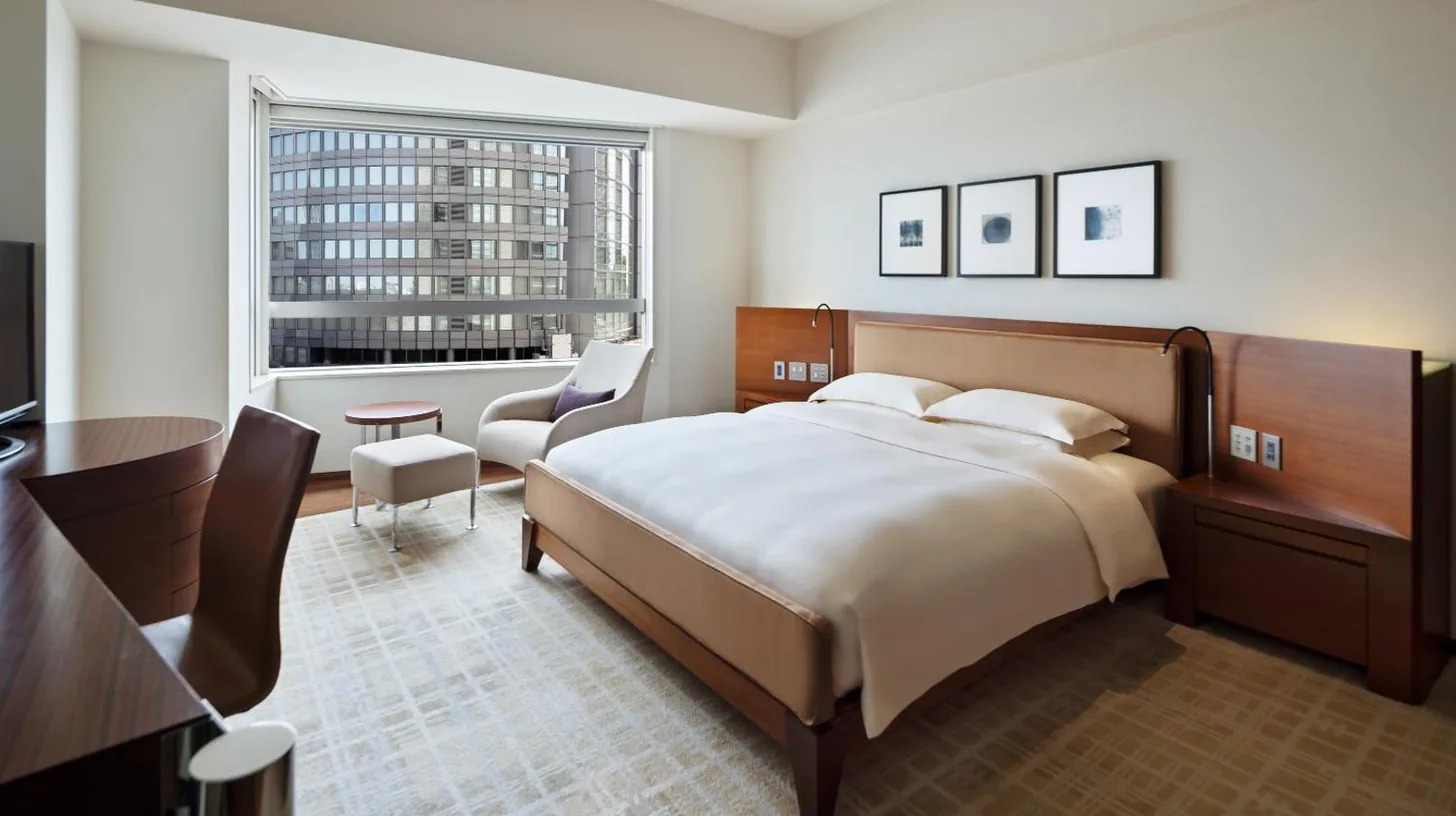 a bedroom with a large bed and a large window at Grand Hyatt Tokyo in Tokyo