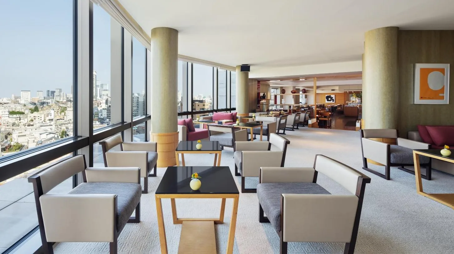 a hotel lobby with chairs and tables and windows at Grand Hyatt Tokyo in Tokyo