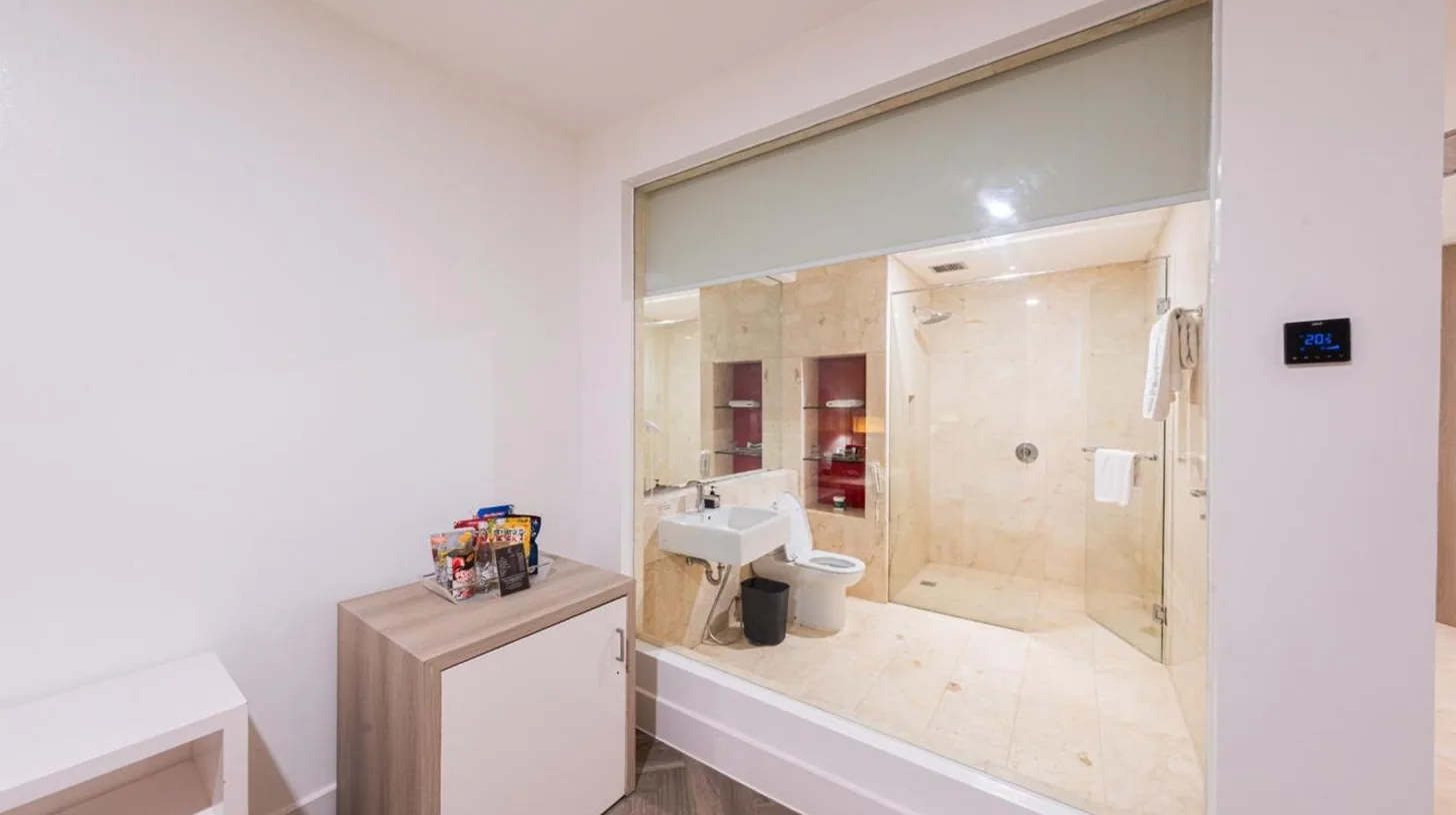 an office with a desk and a chair at Grand Jatra Hotel Balikpapan in Balikpapan