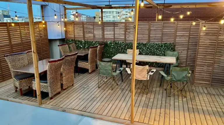 a patio with a table and chairs on a deck at Hotel EL Utsunomiya 7 free parking in Utsunomiya