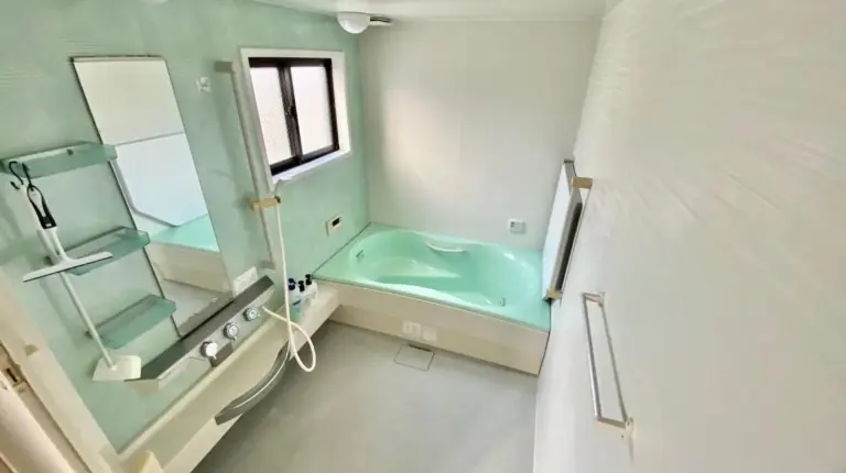 a bathroom with a tub and a sink and a mirror at Hotel EL Utsunomiya 7 free parking in Utsunomiya