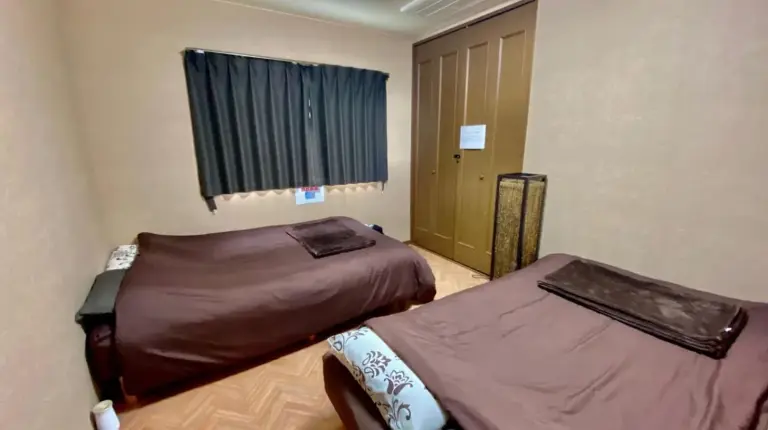 a bedroom with two beds and a skylight at Hotel EL Utsunomiya 7 free parking in Utsunomiya