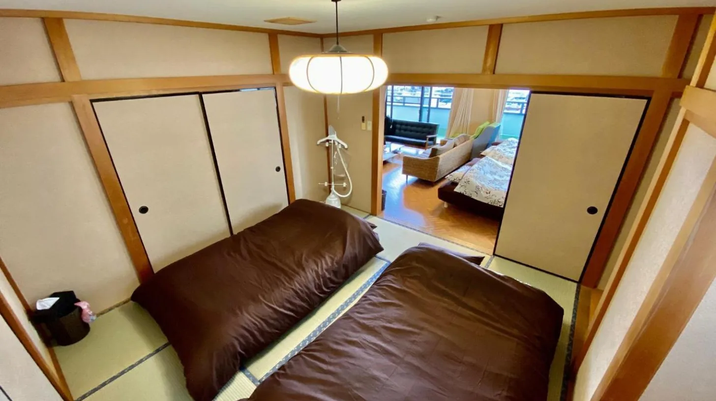 a small room with a brown couch in a room at Hotel EL Utsunomiya 7 free parking in Utsunomiya