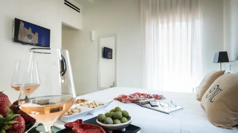 a woman sitting in front of a tray of food at Hotel Metropole Taormina in Taormina