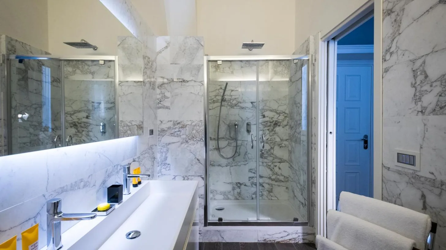 a hotel swimming pool with a view of the ocean at Hotel Metropole Taormina in Taormina