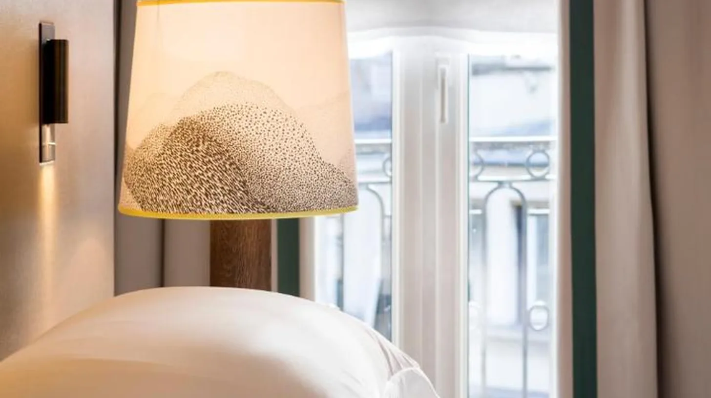 una sala de estar con sofÃ¡ y mesa en Hyatt Paris Madeleine en ParÃ­s