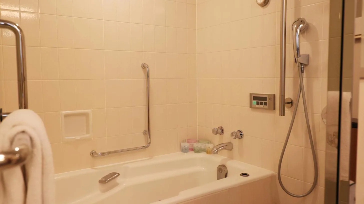 ein Badezimmer mit einer Badewanne mit Dusche im Imperial Hotel Tokyo in Tokio