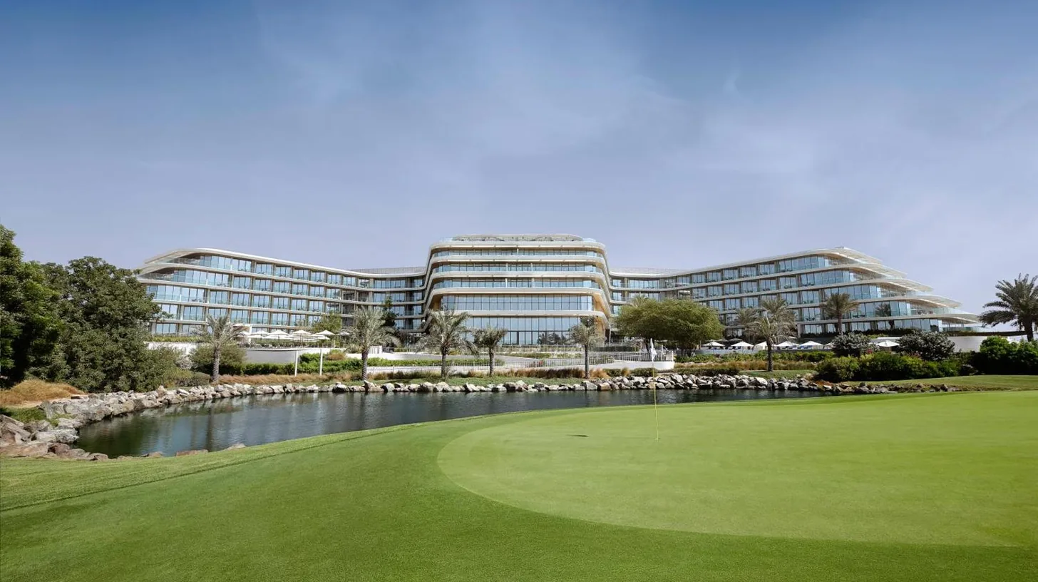 a golf course in front of a large building at JA Lake View Hotel