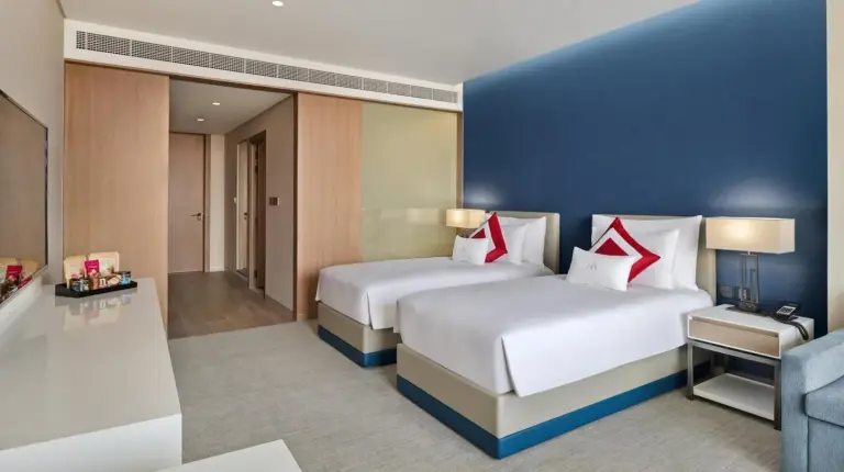 a hotel room with a large bed and a desk at JA Lake View Hotel