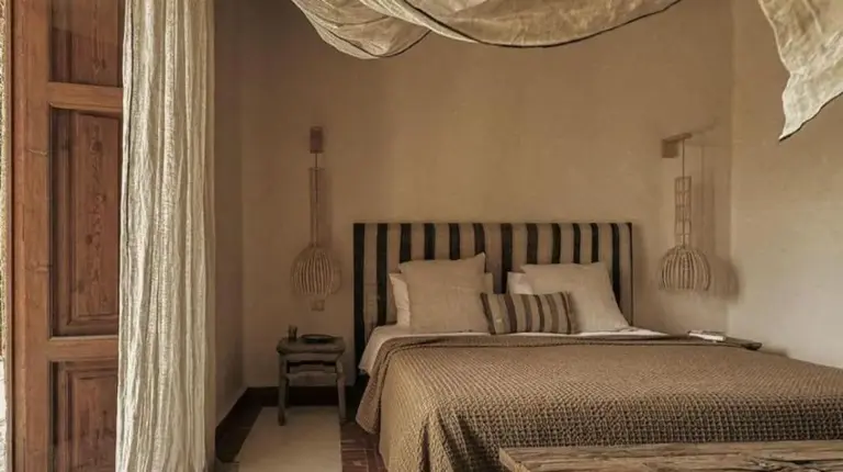 a bedroom with a large bed with a mosquito net at Kasbah d'if in Marrakech