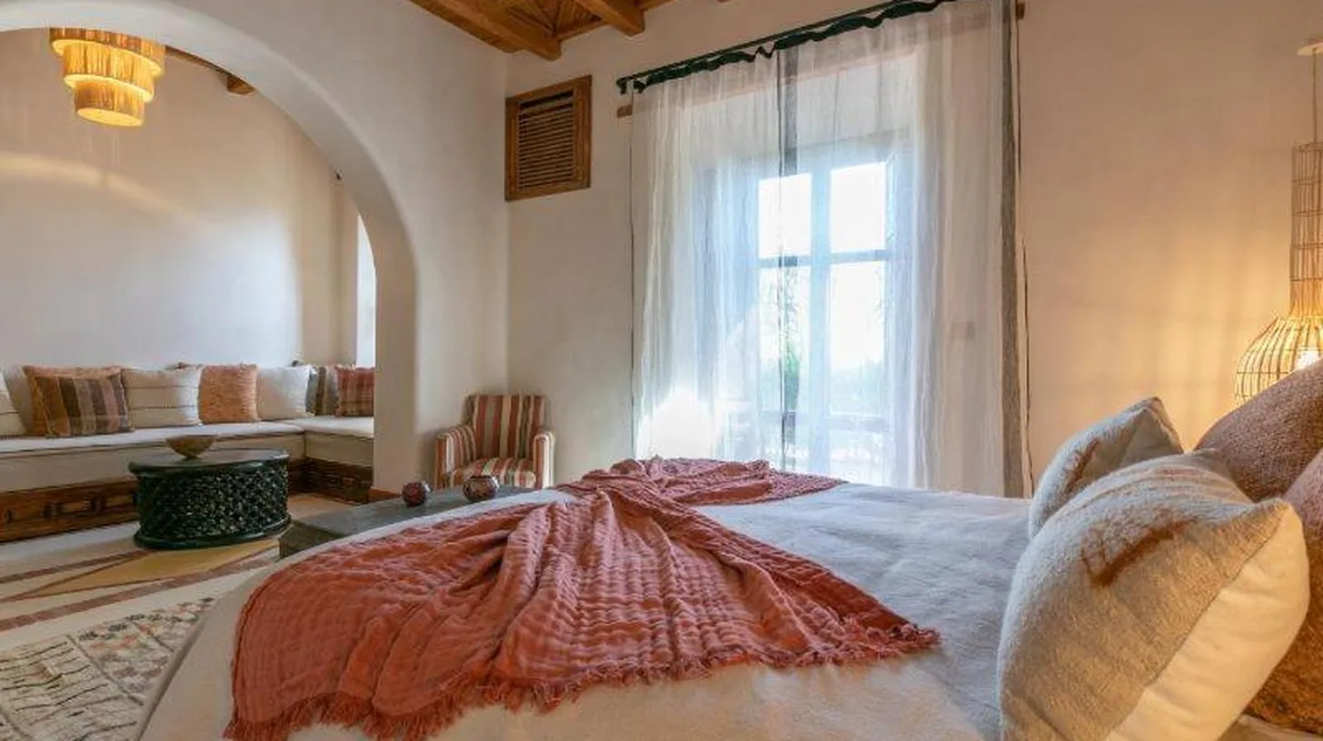 a bedroom with a large bed with a window at Kasbah d'if in Marrakech