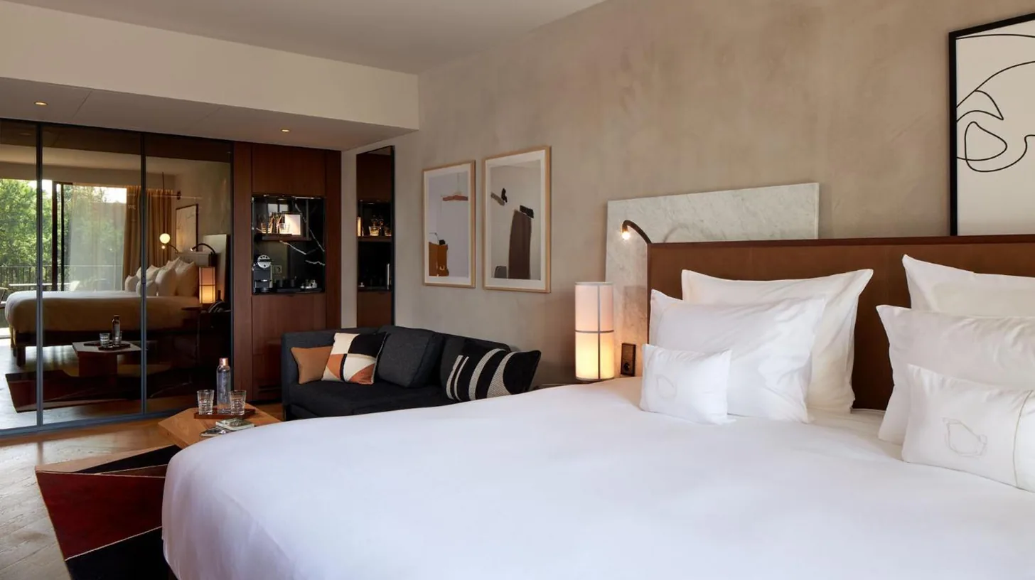 a balcony with furniture and a view of a city at L'Esquisse Hotel & Spa Colmar - MGallery Collection in Colmar