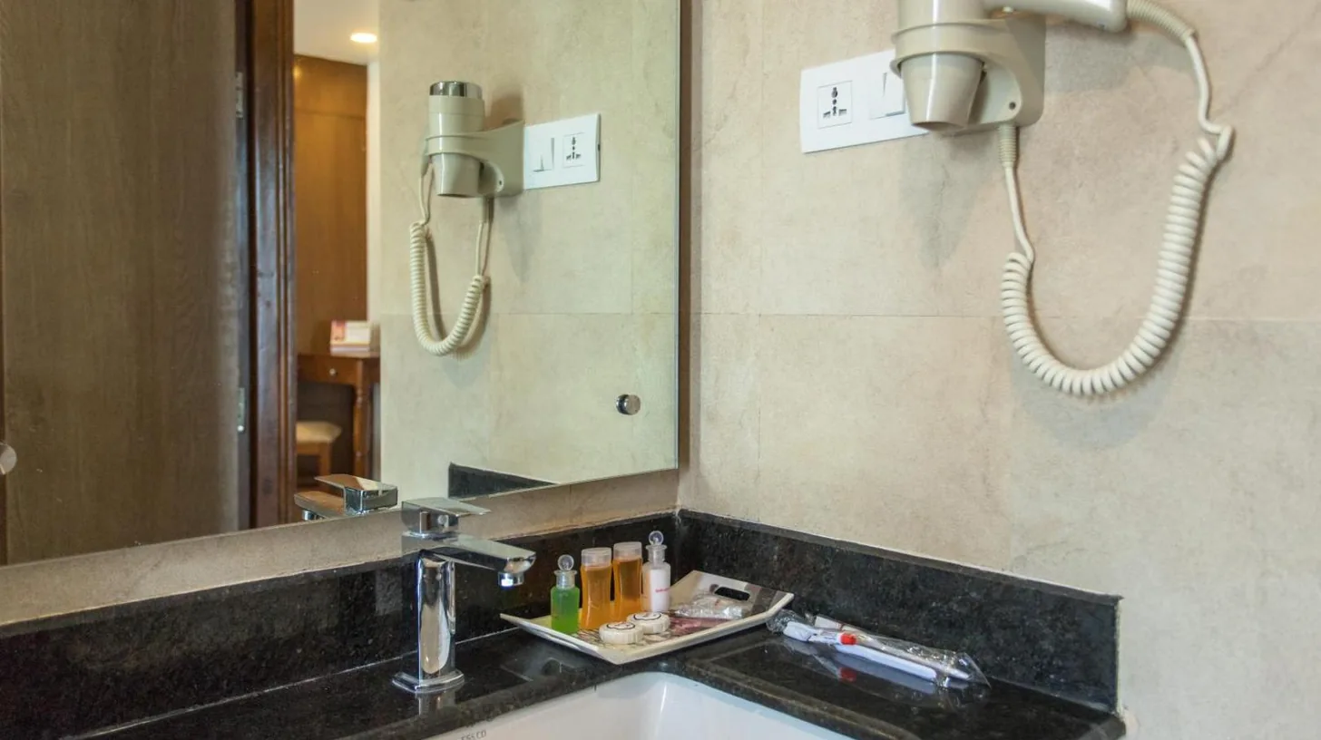 a bathroom with a sink and a mirror at Landmark Pokhara in Pokhara