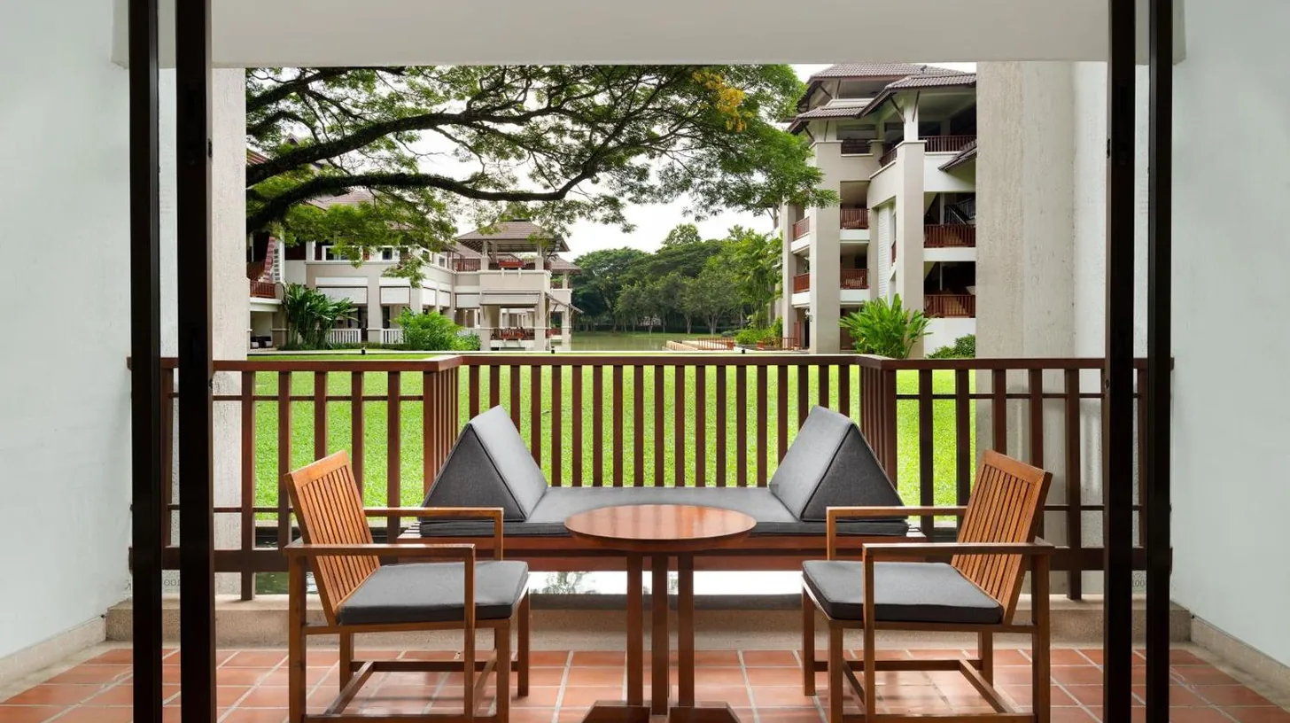 a hotel room with two beds and a television at Le Meridien Chiang Rai Resort