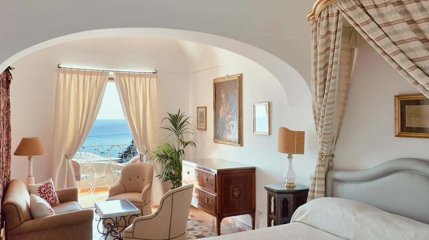 a bedroom with a bed and a room with a view at Le Sirenuse in Positano