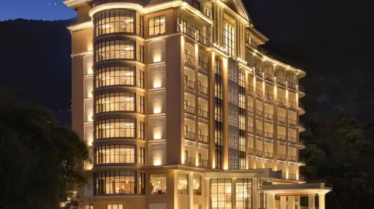 a large building with lights in front of it at night at Lemon Tree Premier Budhanilkantha Kathmandu