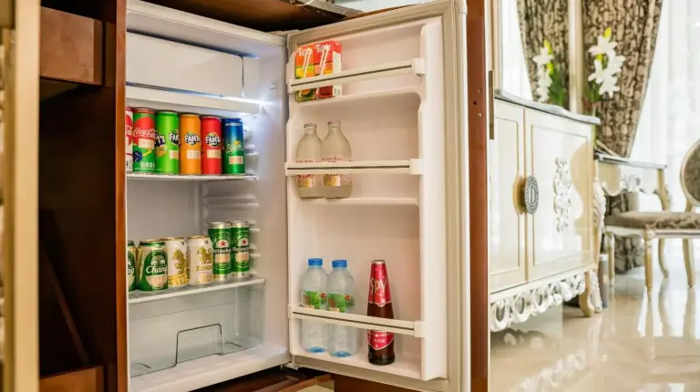 an open refrigerator filled with drinks and soda at LK Emerald Beach - SHA Extra Plus in Pattaya North