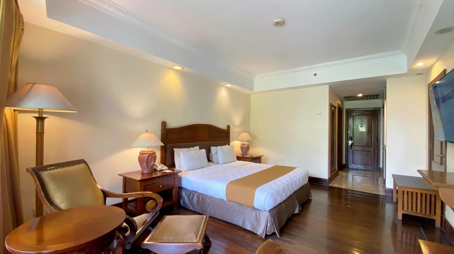a hotel room with a bed and a desk at Lorin Solo Hotel in Solo