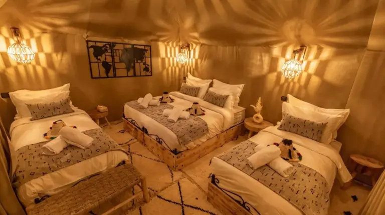 a bedroom with two beds with teddy bears on them at Luna Desert Luxury Camp in Merzouga