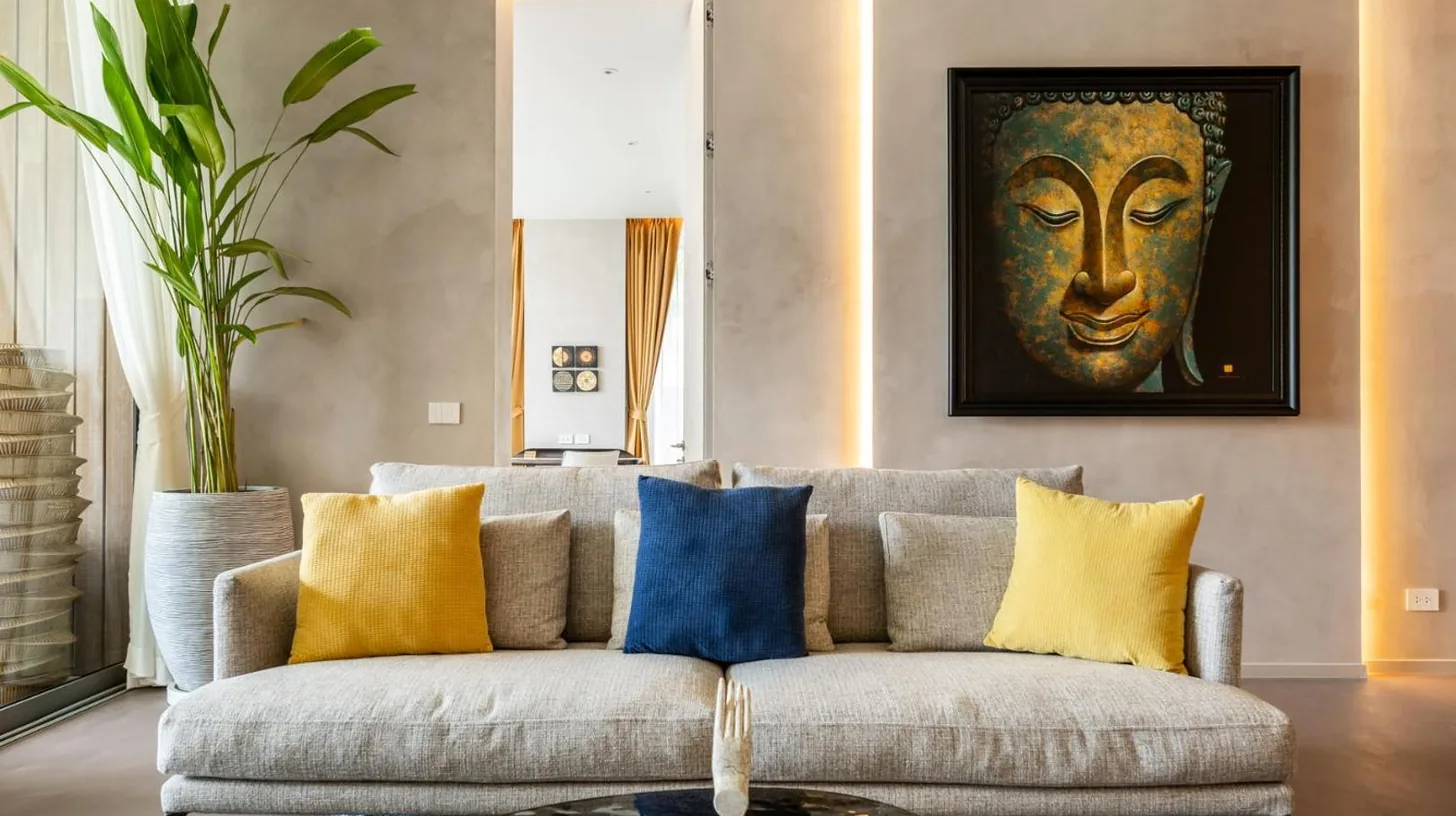 a living room with a couch with yellow and blue pillows at Luxury Penthouse 407sqm Beachfront and private pool in Phuket Town